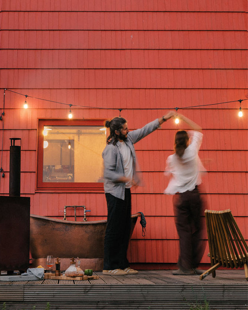 Couple dancing outside our red cabin